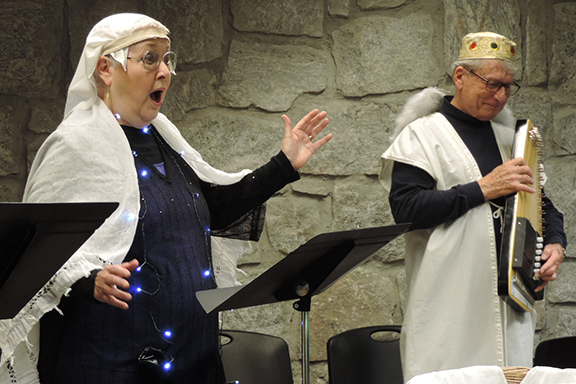 older woman and man acting in makeshift white garb